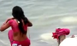 Indian woman bathing in ganges brooklet backless open